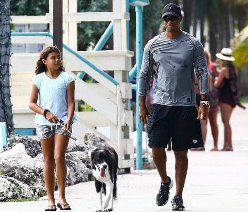 Sam Alexis Woods with her father, Tiger Woods